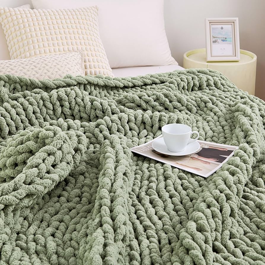 Chunky knit throw blanket draped over apartment couch
